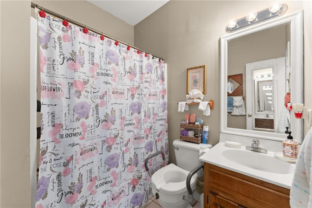 716 Michael Drive Winder, GA 30680 - Photo 26 of 46 a bathroom with a sink toilet and shower