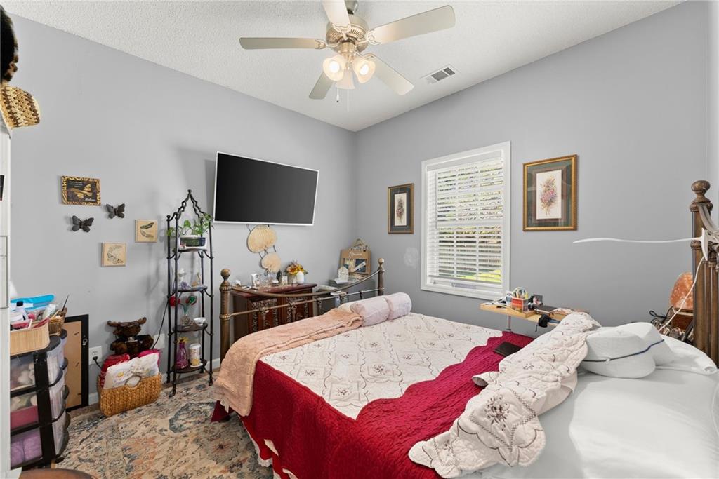 716 Michael Drive Winder, GA 30680 - Photo 27 of 46 a bedroom with a bed and a flat screen tv