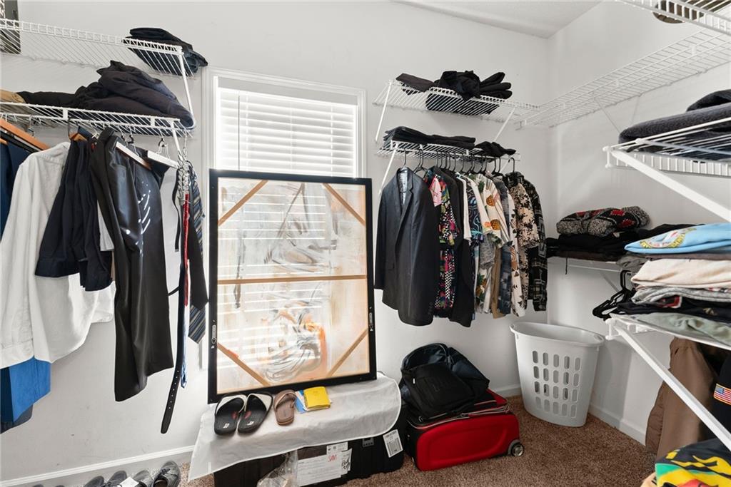 716 Michael Drive Winder, GA 30680 - Photo 32 of 46 a view of walk in closet with clothes and shoes