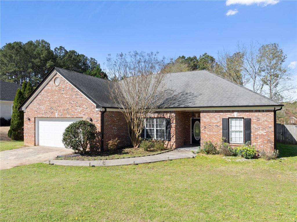716 Michael Drive Winder, GA 30680 - Photo 4 of 46 a view of a house with backyard and a tree