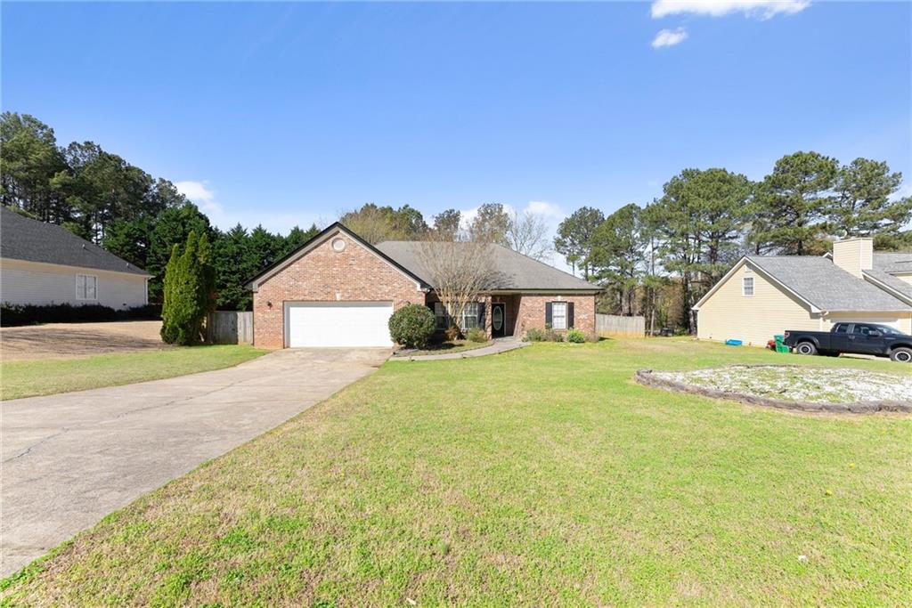716 Michael Drive Winder, GA 30680 - Photo 5 of 46 a front view of a house with a yard and garage