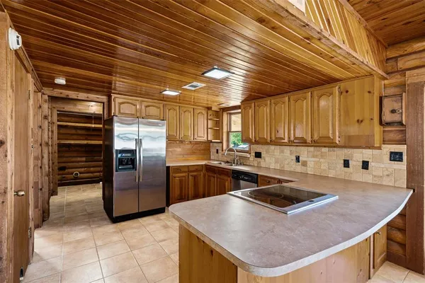 a kitchen with stainless steel appliances granite countertop a sink a stove and a refrigerator