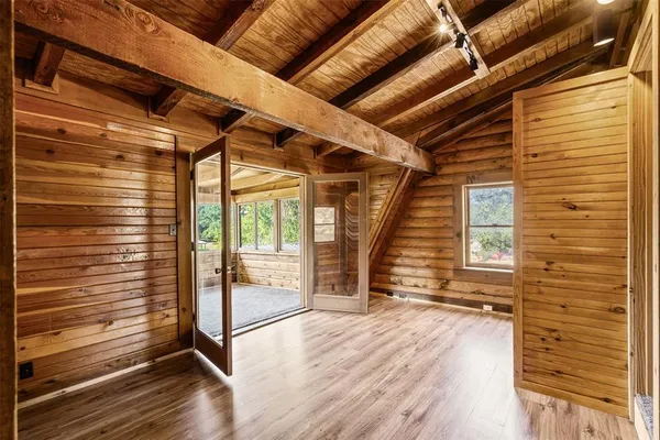 a view of a room with wooden floor