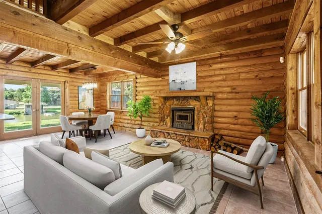 a living room with furniture a fireplace and a table