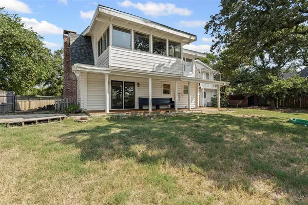 a view of a house with a backyard