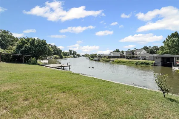 a view of a lake with houses in the back