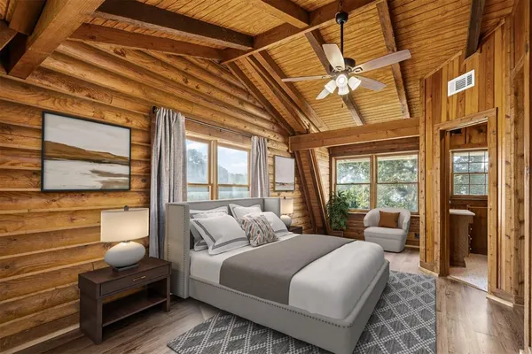 a bedroom with a large bed and a large window