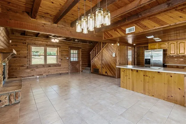 a kitchen with stainless steel appliances granite countertop a sink a stove and a refrigerator
