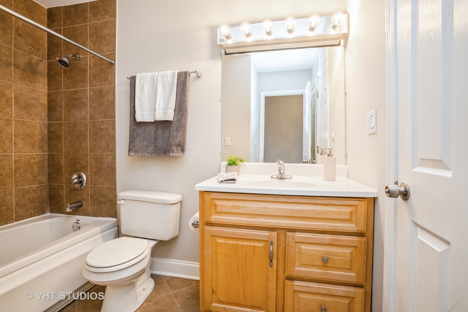 850 South Lorraine Road, Unit 1E Wheaton, IL 60189 - Photo 13 of 15 a bathroom with a sink toilet vanity and shower