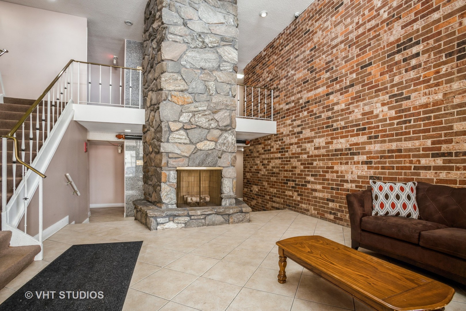 850 South Lorraine Road, Unit 1E Wheaton, IL 60189 - Photo 4 of 15 a living room with furniture and a fireplace