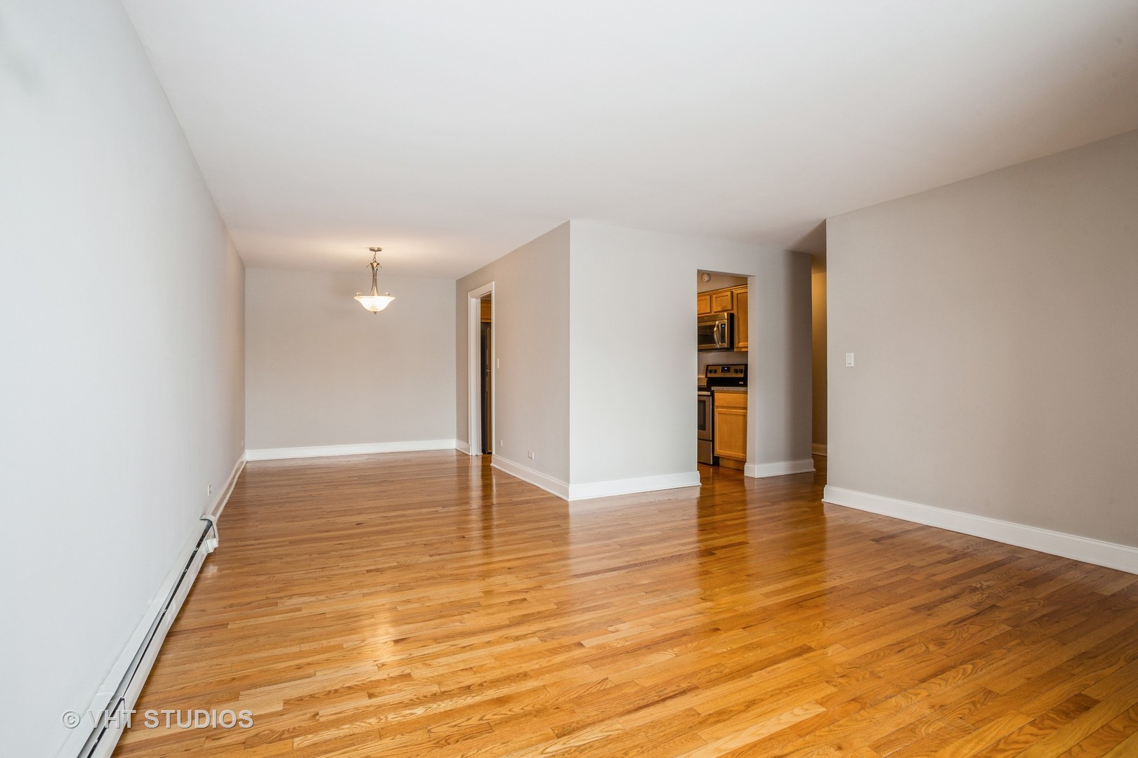 850 South Lorraine Road, Unit 1E Wheaton, IL 60189 - Photo 7 of 15 a view of an empty room with wooden floor and a window
