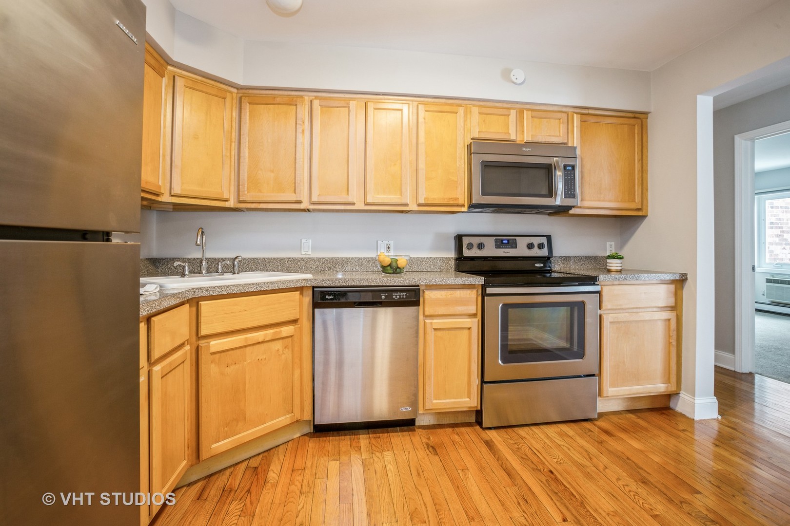 850 South Lorraine Road, Unit 1E Wheaton, IL 60189 - Photo 8 of 15 a kitchen with stainless steel appliances granite countertop a stove a sink and a microwave