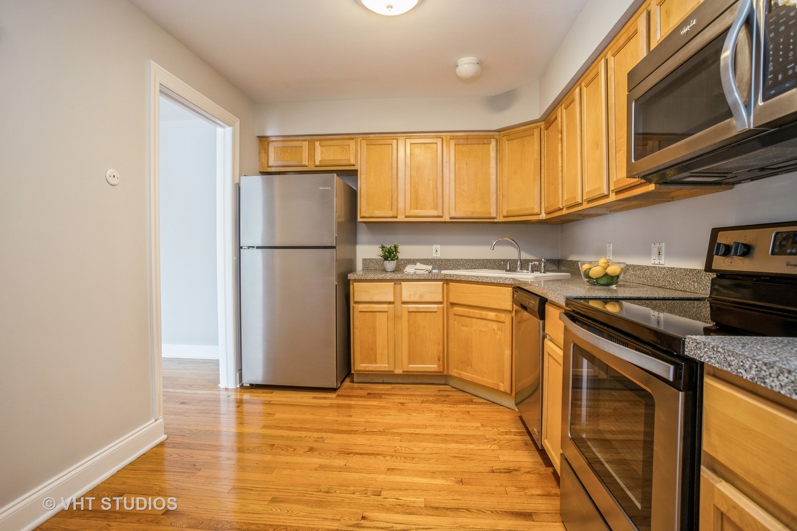 850 South Lorraine Road, Unit 1E Wheaton, IL 60189 - Photo 9 of 15 a kitchen with stainless steel appliances granite countertop a refrigerator a sink dishwasher a stove with wooden cabinets