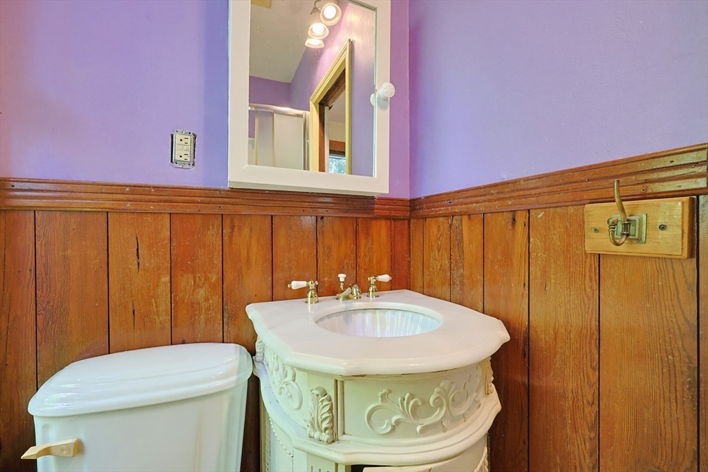 7 Baker Street Worcester, MA 01603 - Photo 21 of 42 a bathroom with a sink a toilet and mirror