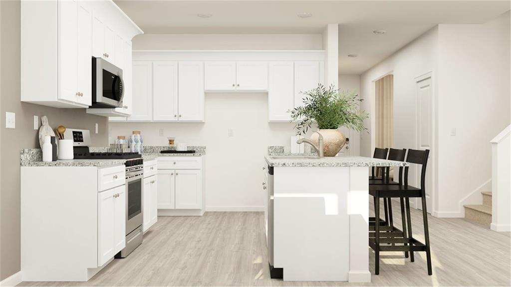 116 Beautiful Way Locust Grove, GA 30248 - Photo 24 of 35 a kitchen with cabinets and chair