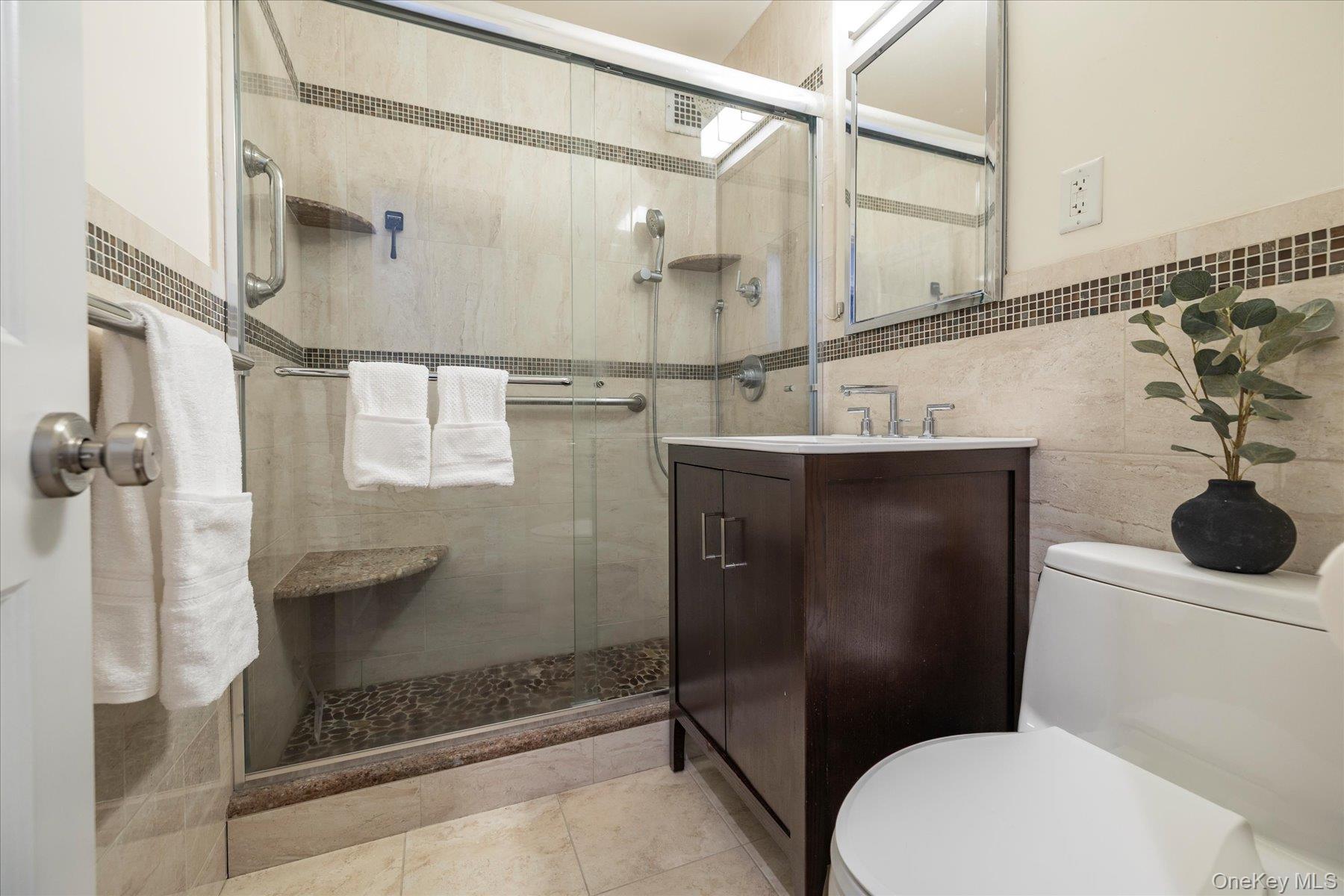 522 Shore Road, Unit 5T Long Beach, NY 11561 - Photo 10 of 22 Fully renovated bathroom with sliding glass shower doors