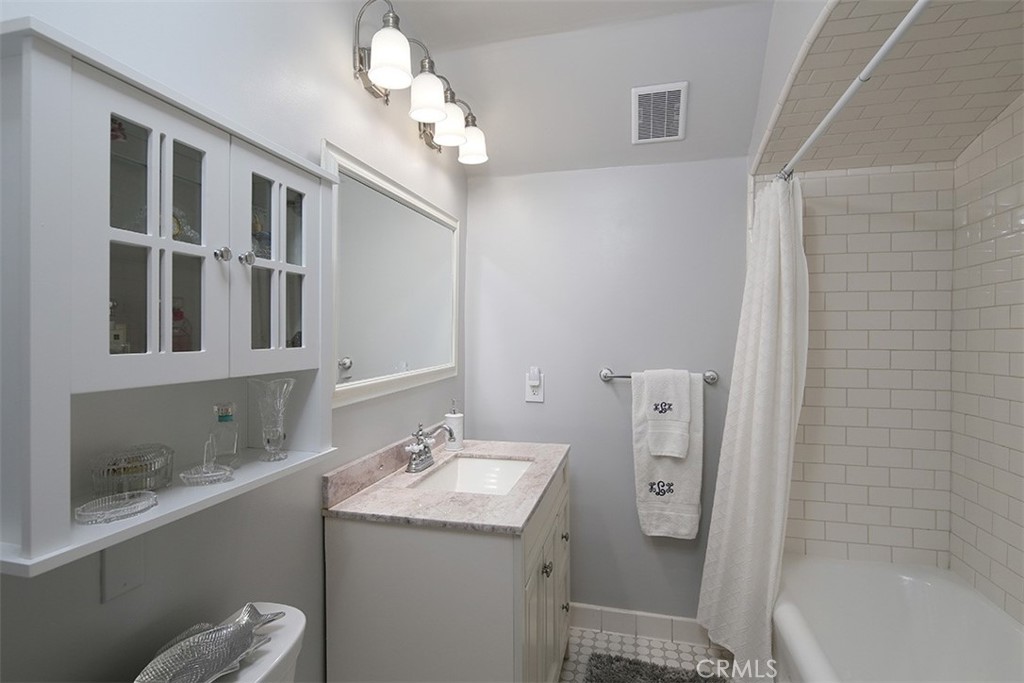 847 Victoria Drive Pasadena, CA 91104 - Photo 17 of 21 a bathroom with a sink a toilet and shower