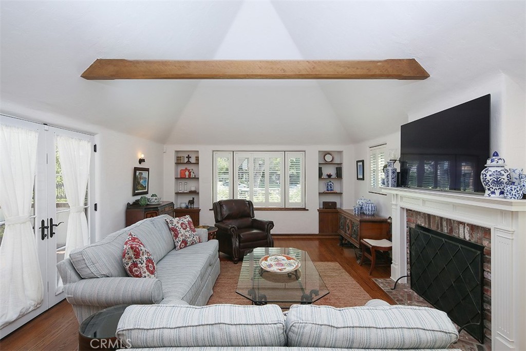 847 Victoria Drive Pasadena, CA 91104 - Photo 6 of 21 a living room with furniture a flat screen tv and a fireplace