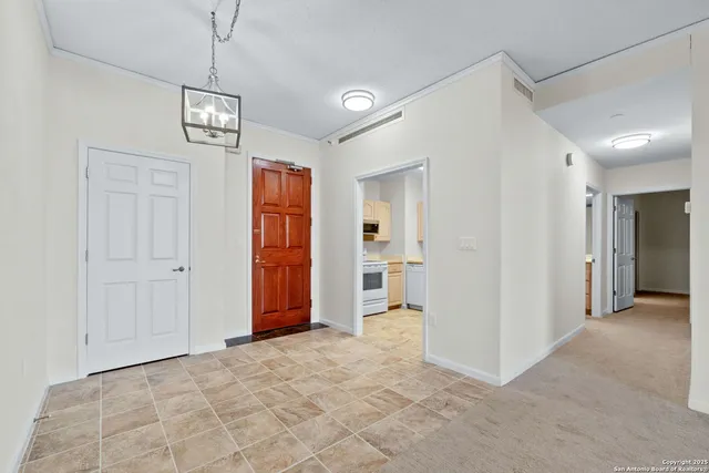 a view of a hallway with wooden shelves