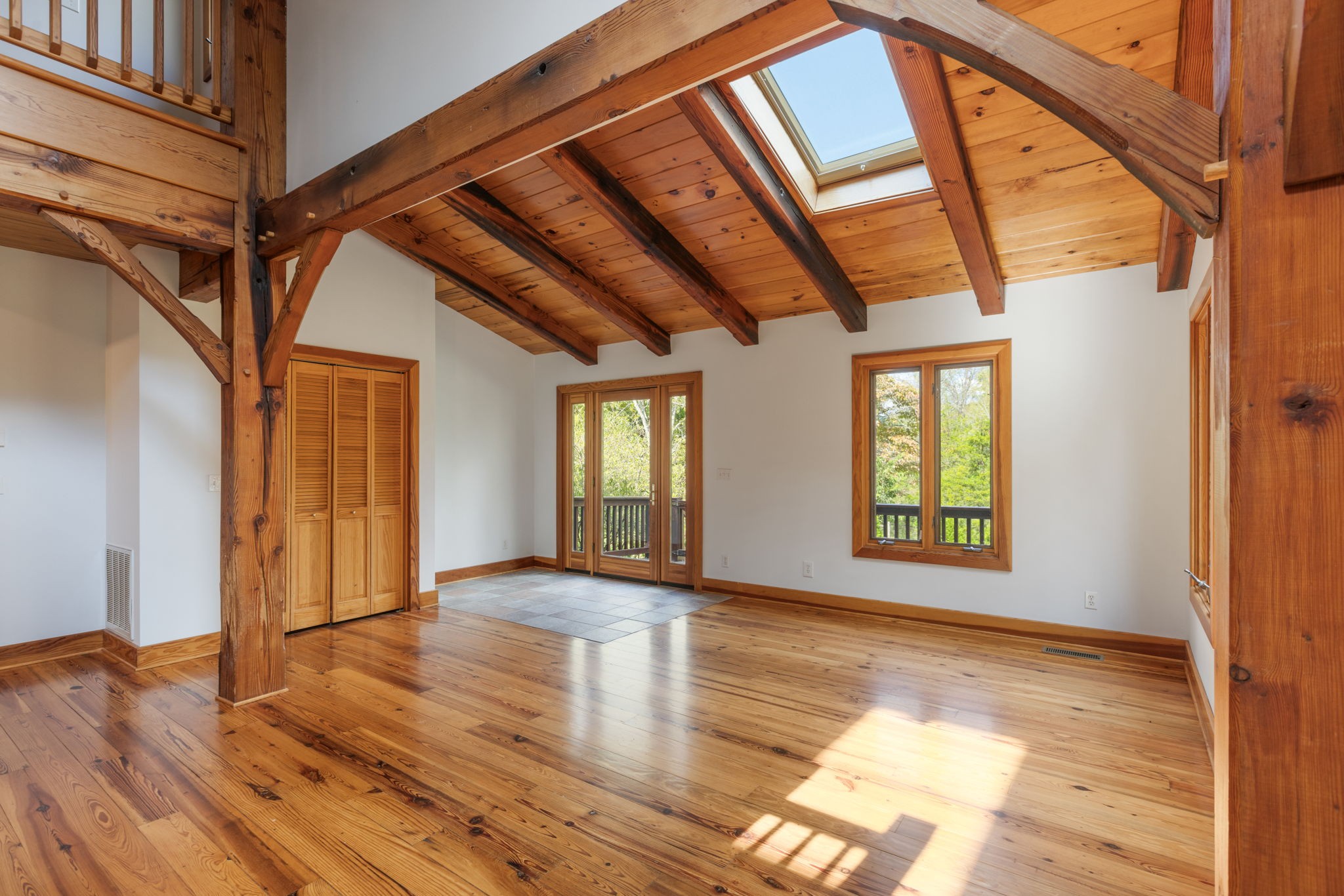7725 Caney Fork Road Fairview, TN 37062 - Photo 8 of 58 a view of an empty room with wooden floor and windows