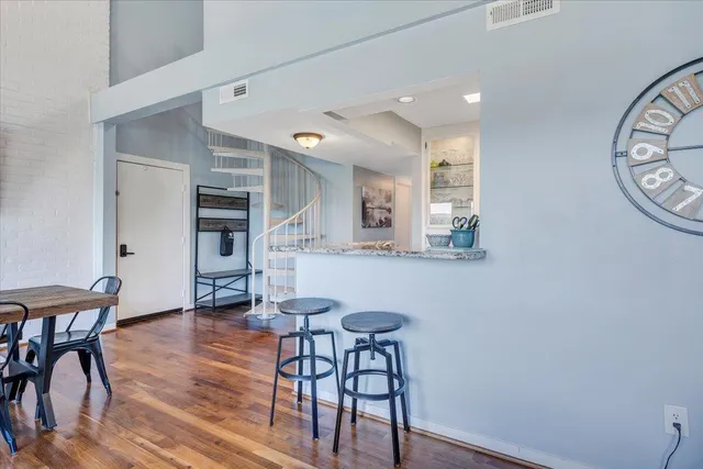 a bedroom with a bed a mirror and wooden floor