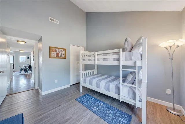 a view of a brick house with a yard and large trees