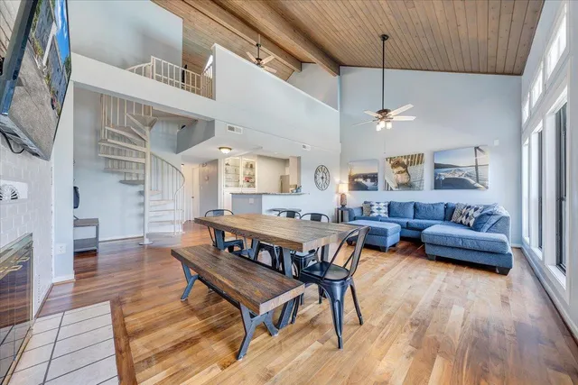 a living room with furniture dining table and a flat screen tv