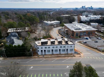 a aerial view of a large building with a mountain in the background