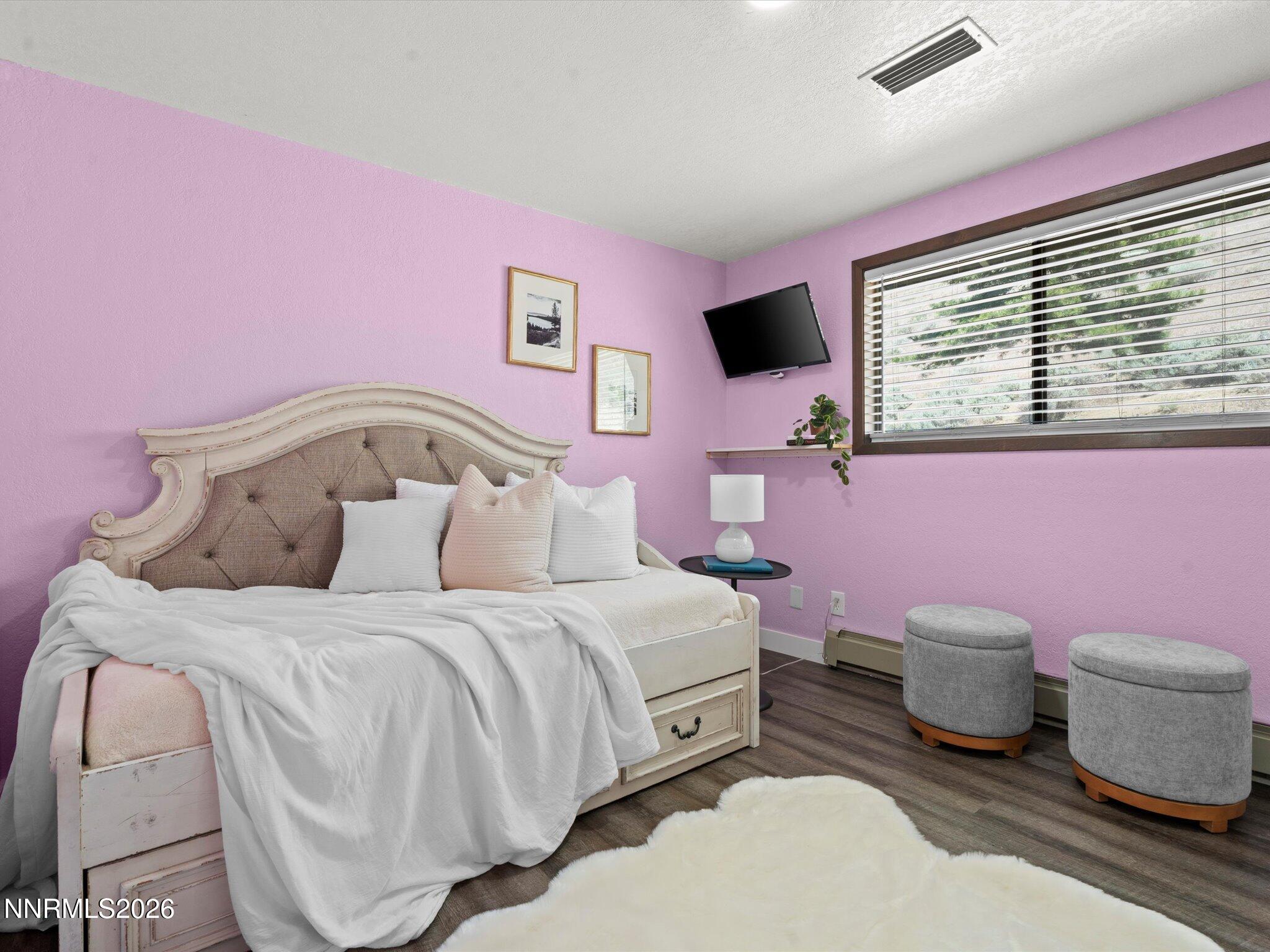 20449 Temelec Way Reno, NV 89521 - Photo 35 of 65 a bedroom with a bed and wooden floor