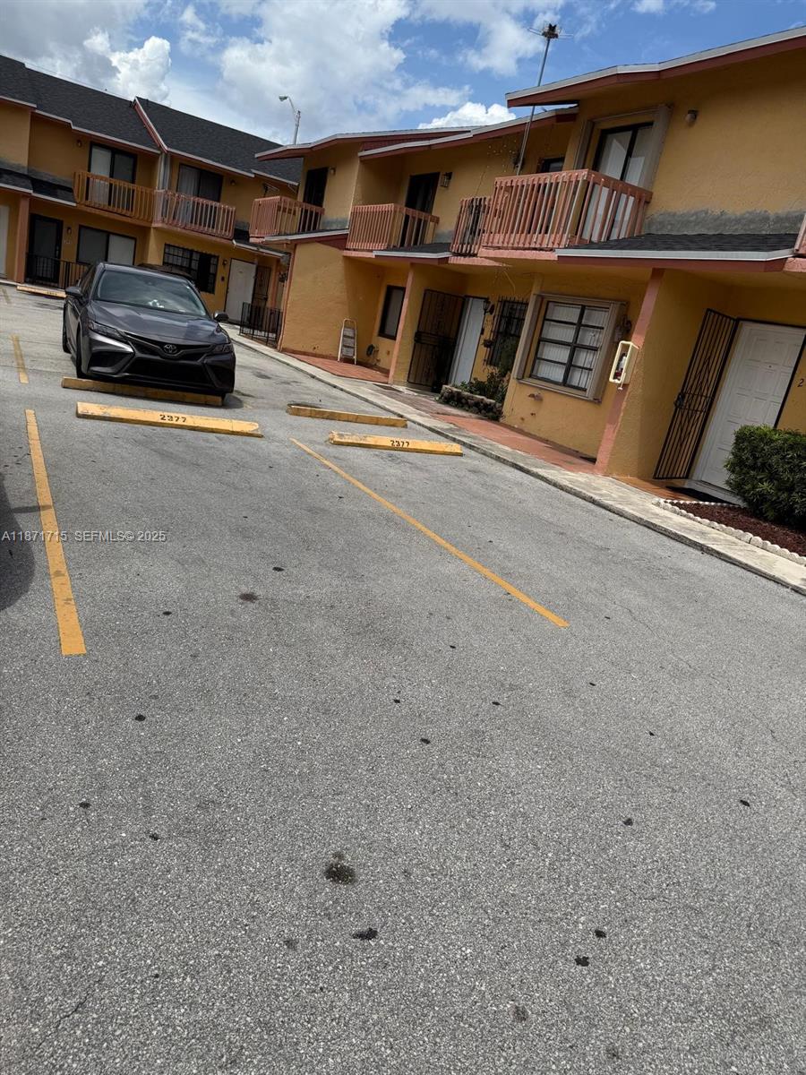 2377 West 66th Place, Unit 204 Hialeah, FL 33016 - Photo 1 of 17 a living room with furniture and a fireplace