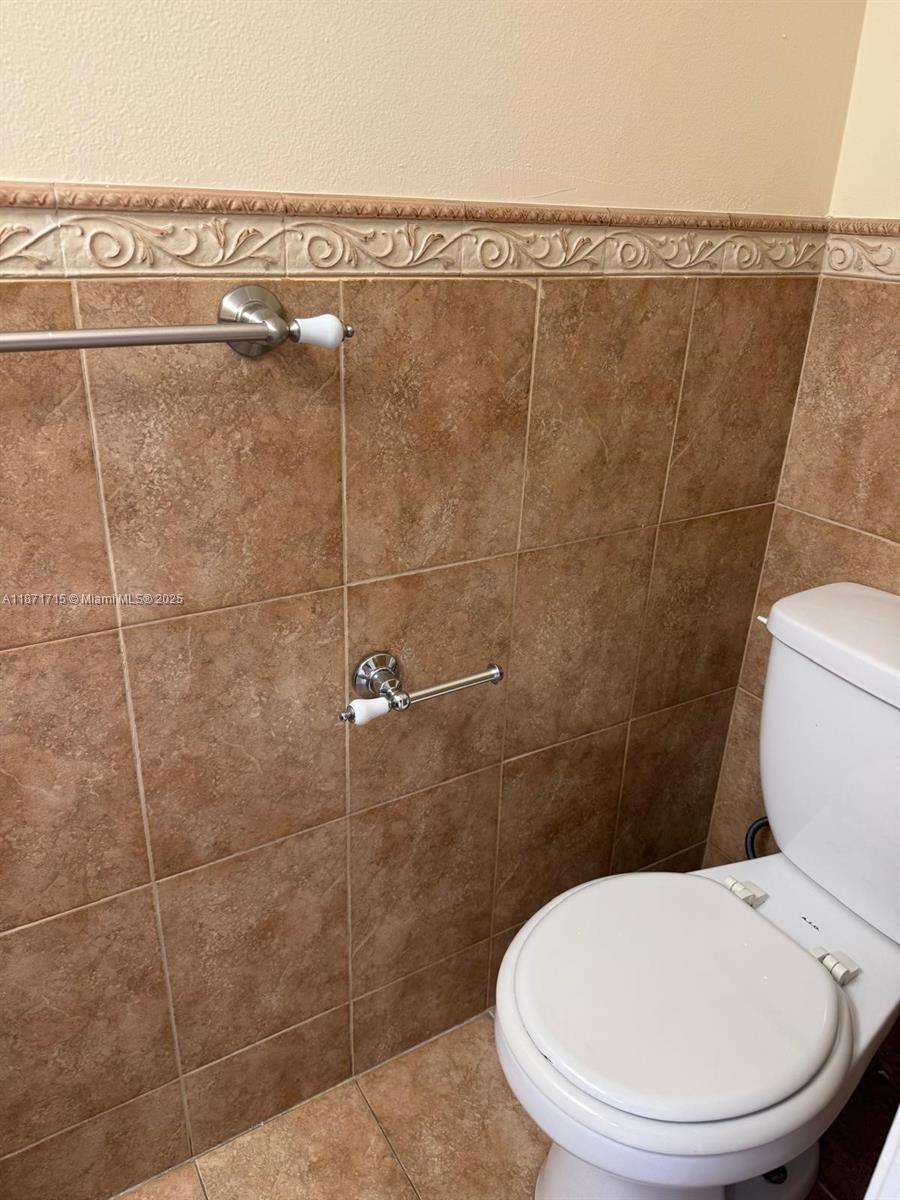 2377 West 66th Place, Unit 204 Hialeah, FL 33016 - Photo 15 of 17 a bathroom with a toilet and a shower