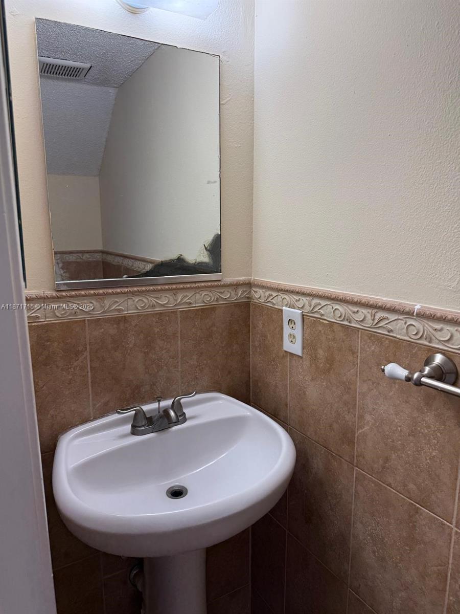 2377 West 66th Place, Unit 204 Hialeah, FL 33016 - Photo 16 of 17 a bathroom with a sink and mirror