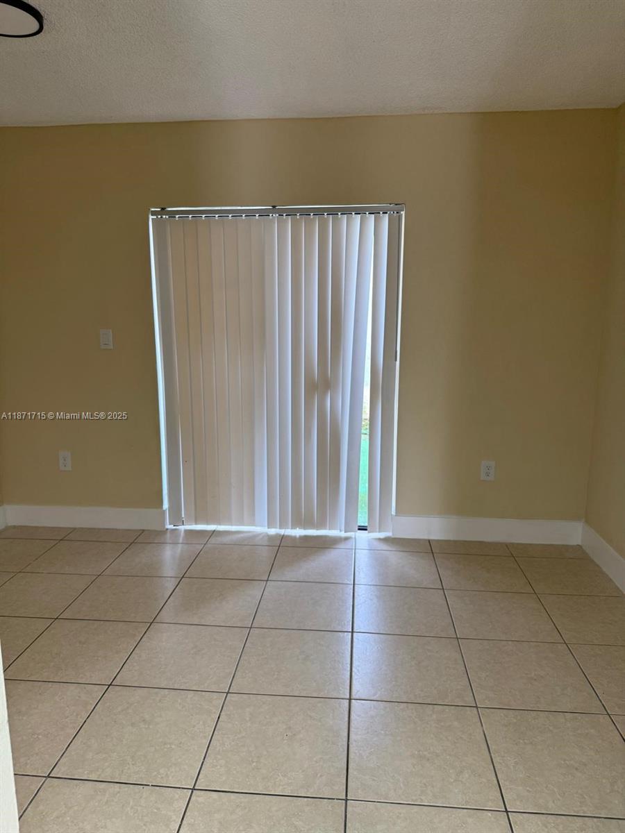 2377 West 66th Place, Unit 204 Hialeah, FL 33016 - Photo 6 of 17 a view of a livingroom with an empty space and a window