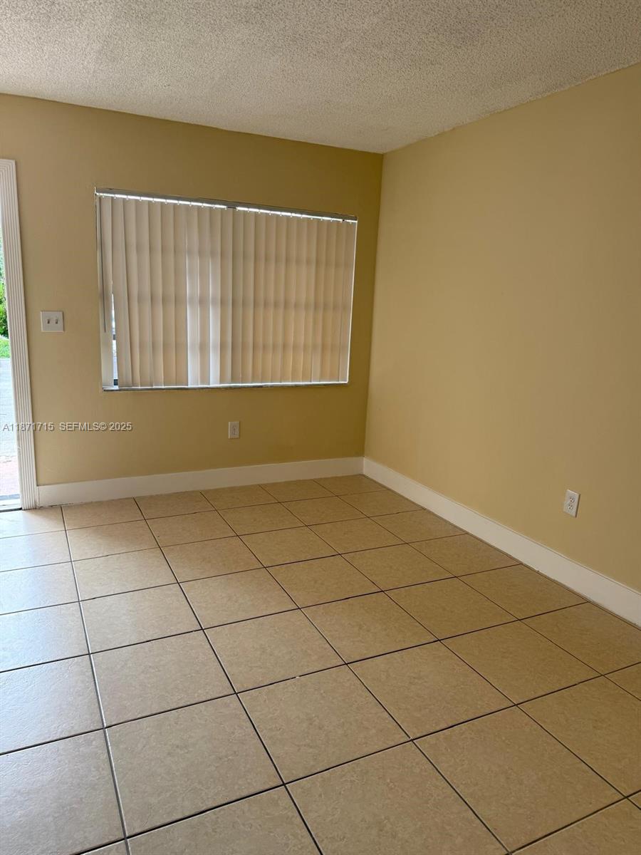 2377 West 66th Place, Unit 204 Hialeah, FL 33016 - Photo 7 of 17 a view of a room with a window