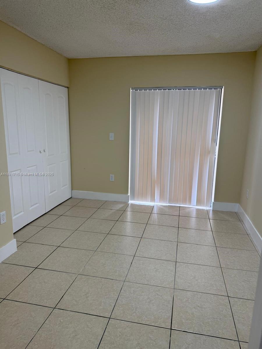 2377 West 66th Place, Unit 204 Hialeah, FL 33016 - Photo 9 of 17 a view of a livingroom with an empty space and a window