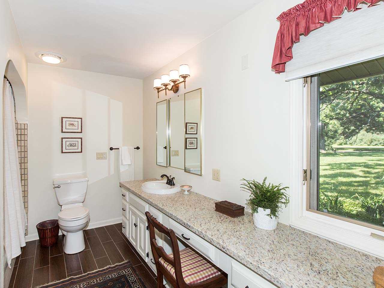 6825 Middle Road South Beloit, IL 61080 - Photo 13 of 23 a spacious bathroom with a granite countertop sink and a mirror
