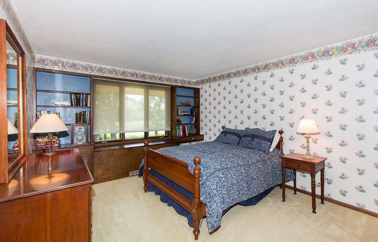 6825 Middle Road South Beloit, IL 61080 - Photo 14 of 23 a bed room with a bed and a chair