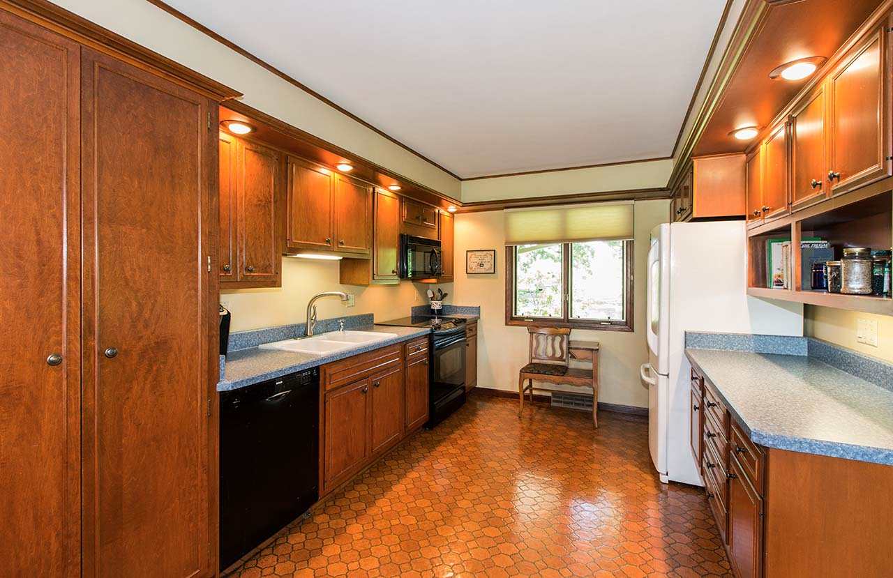 6825 Middle Road South Beloit, IL 61080 - Photo 8 of 23 a kitchen with granite countertop a stove a sink and a refrigerator