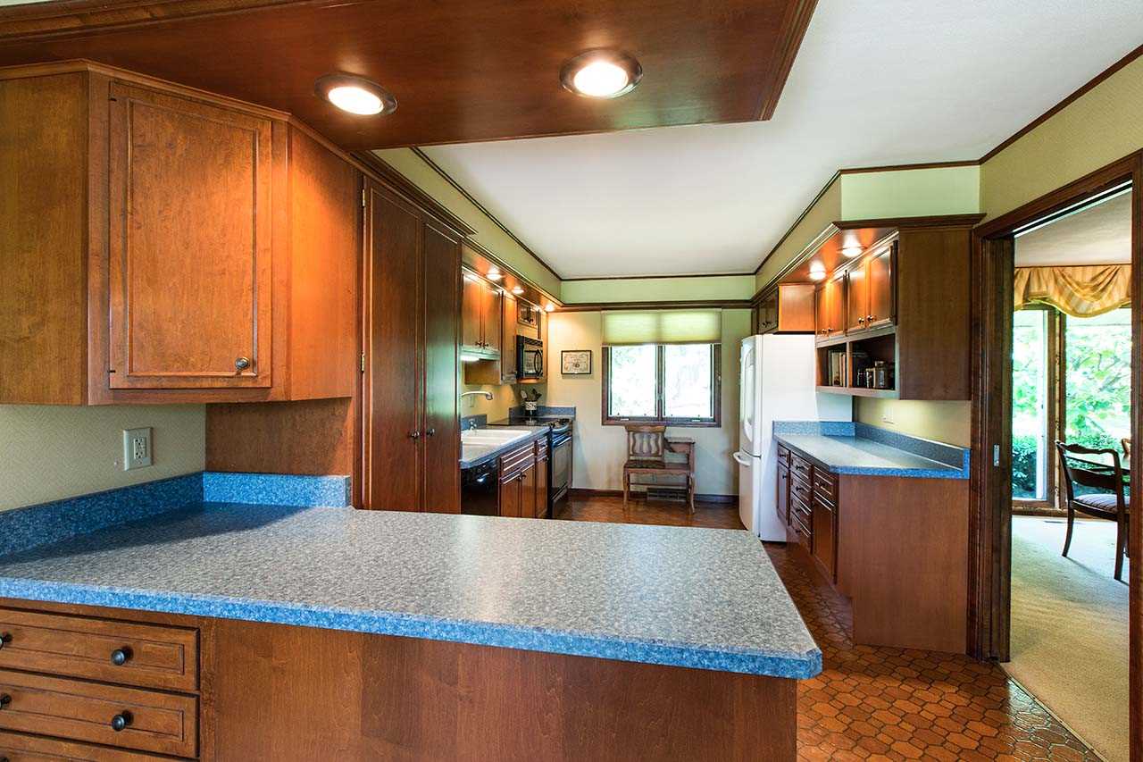6825 Middle Road South Beloit, IL 61080 - Photo 9 of 23 a large kitchen with stainless steel appliances granite countertop a refrigerator a stove and a wooden cabinets