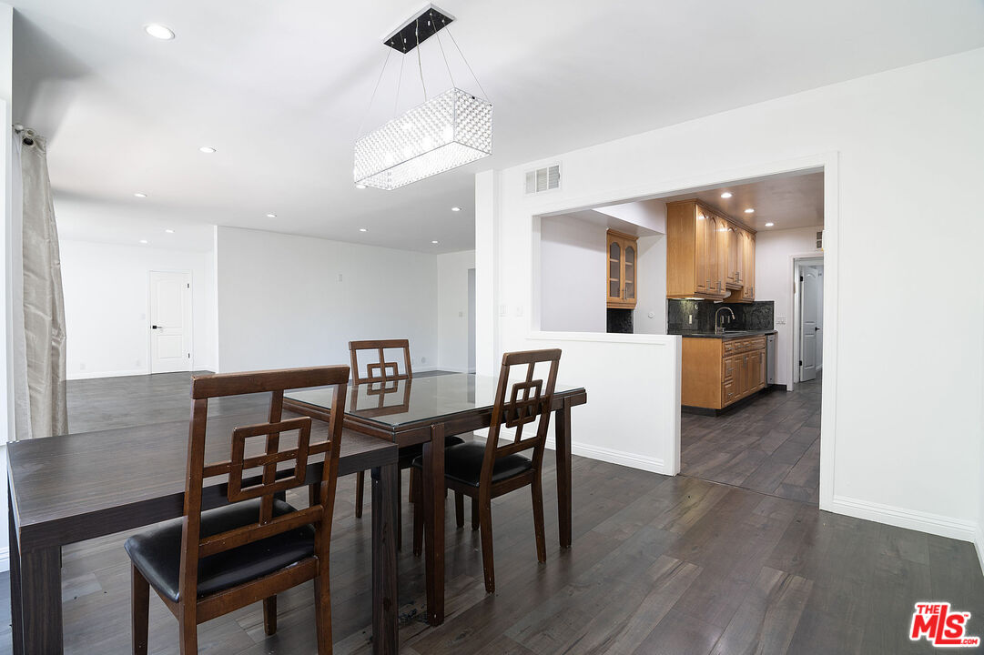 853 Le Doux Road, Unit 201 Los Angeles, CA 90035 - Photo 12 of 36 a view of a dining room with furniture and wooden floor