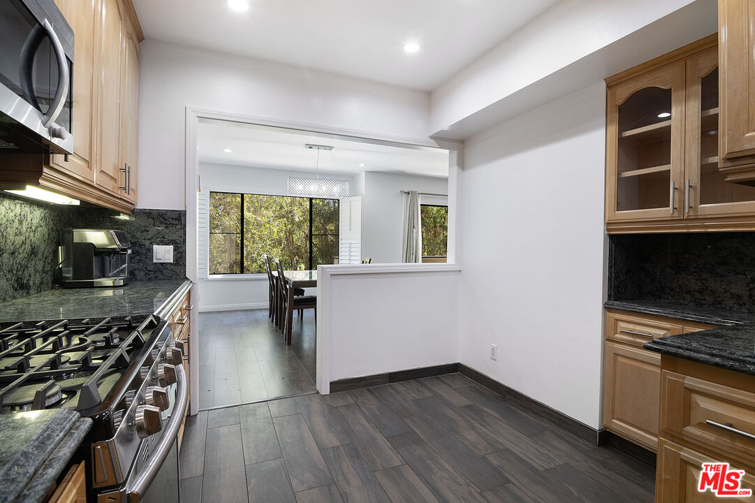 853 Le Doux Road, Unit 201 Los Angeles, CA 90035 - Photo 19 of 36 a kitchen with stainless steel appliances a stove a sink and a microwave