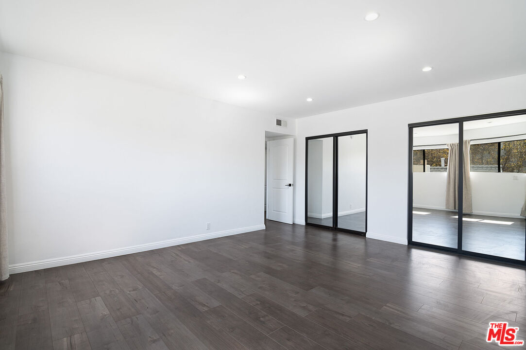 853 Le Doux Road, Unit 201 Los Angeles, CA 90035 - Photo 24 of 36 a view of an empty room with wooden floor
