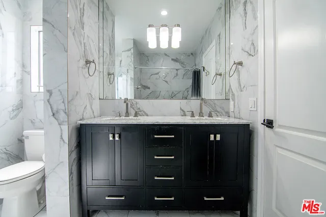a bathroom with a sink vanity and a mirror