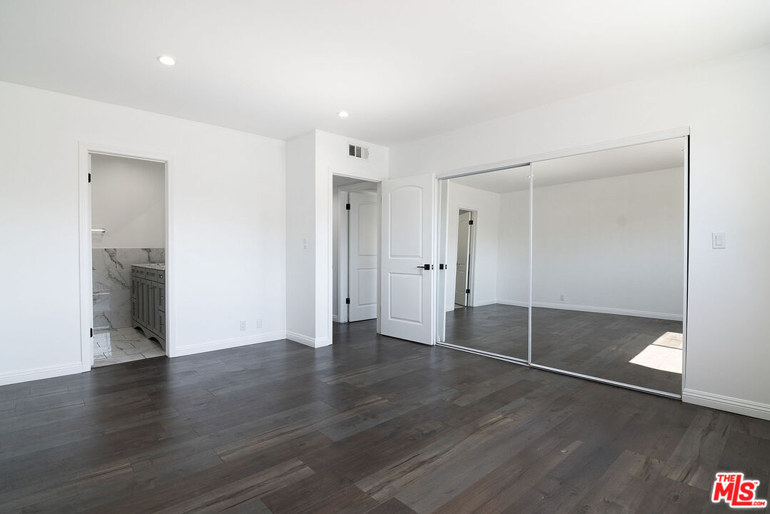 853 Le Doux Road, Unit 201 Los Angeles, CA 90035 - Photo 30 of 36 an empty room with wooden floor and sliding door