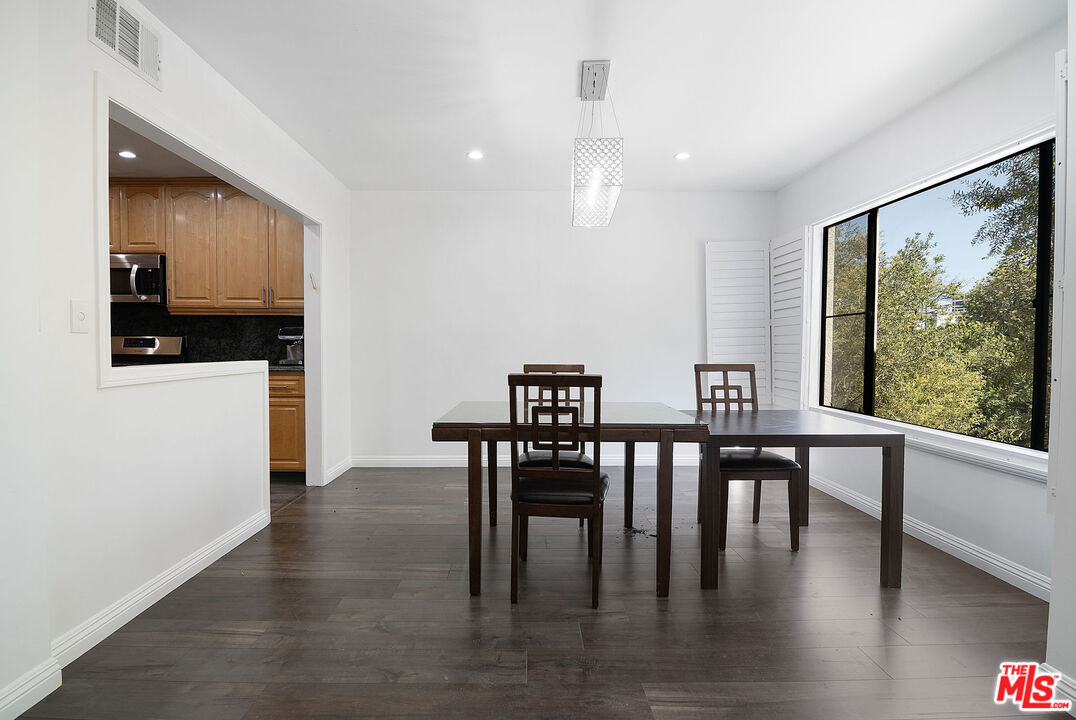 853 Le Doux Road, Unit 201 Los Angeles, CA 90035 - Photo 9 of 36 a view of a dining room with furniture window and wooden floor