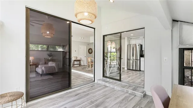 a hallway with wooden floor and bedroom view