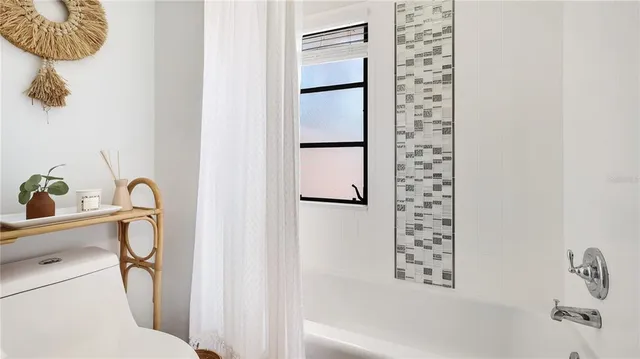 a bathroom with a bathtub and shower