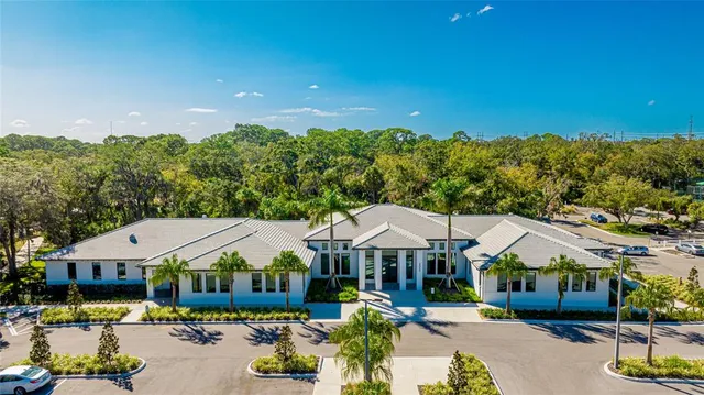 a view of a patio with couches and table and chairs under an umbrella