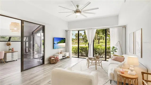 a living room with furniture and large windows