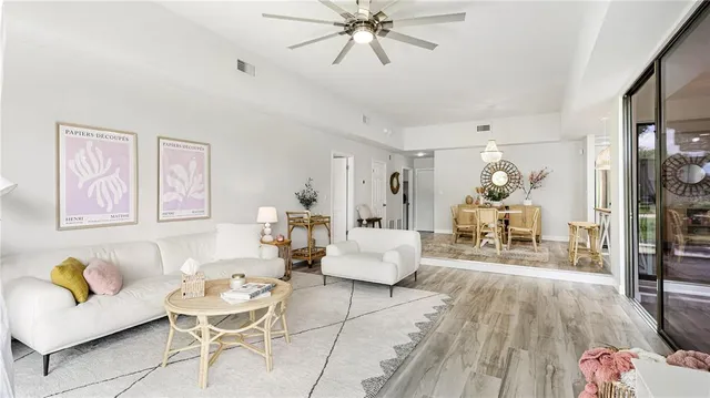 a living room with furniture and wooden floor